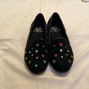 Black flats with rhinestone embellishments.